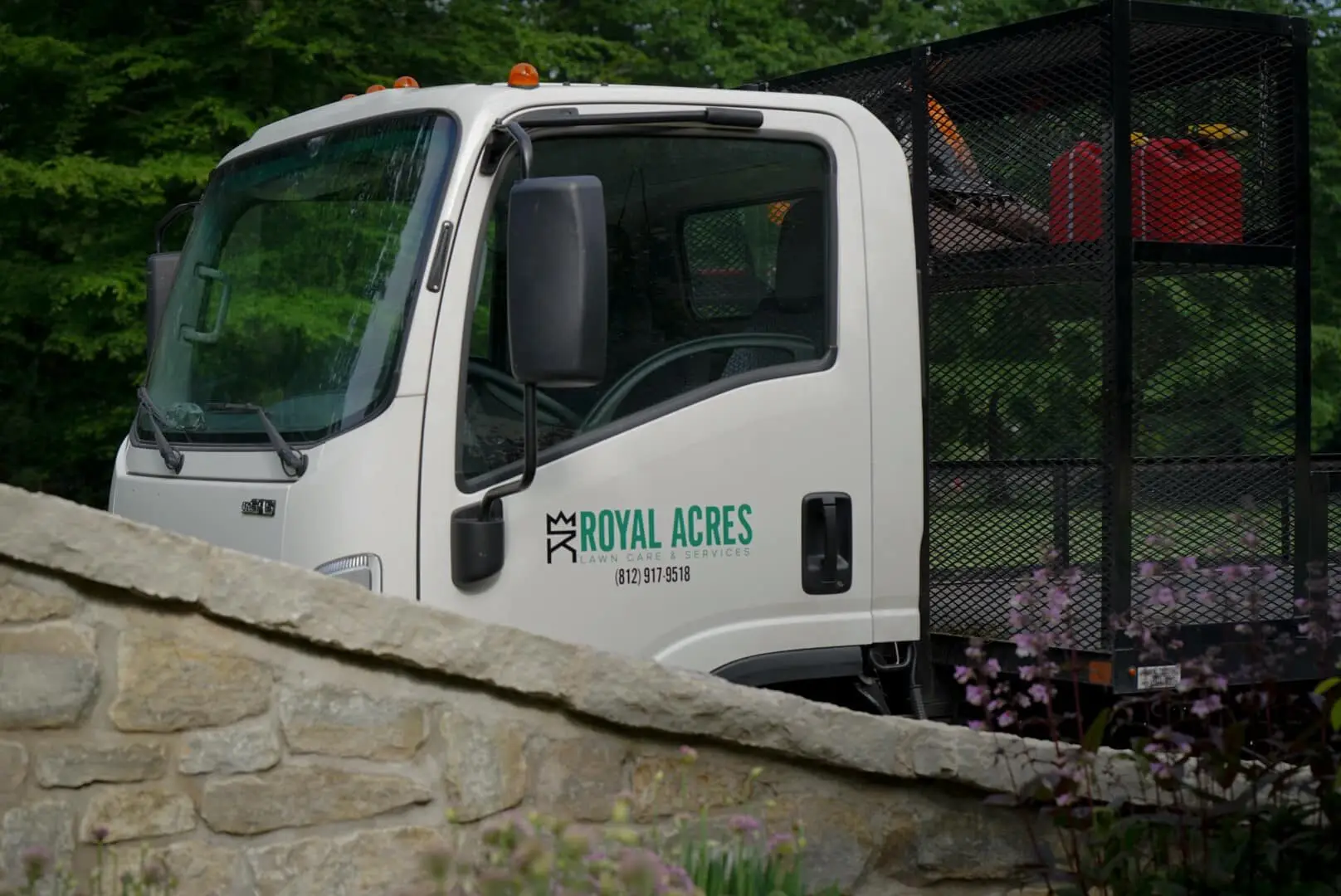 The Royal Acres truck parked behind a stone wall