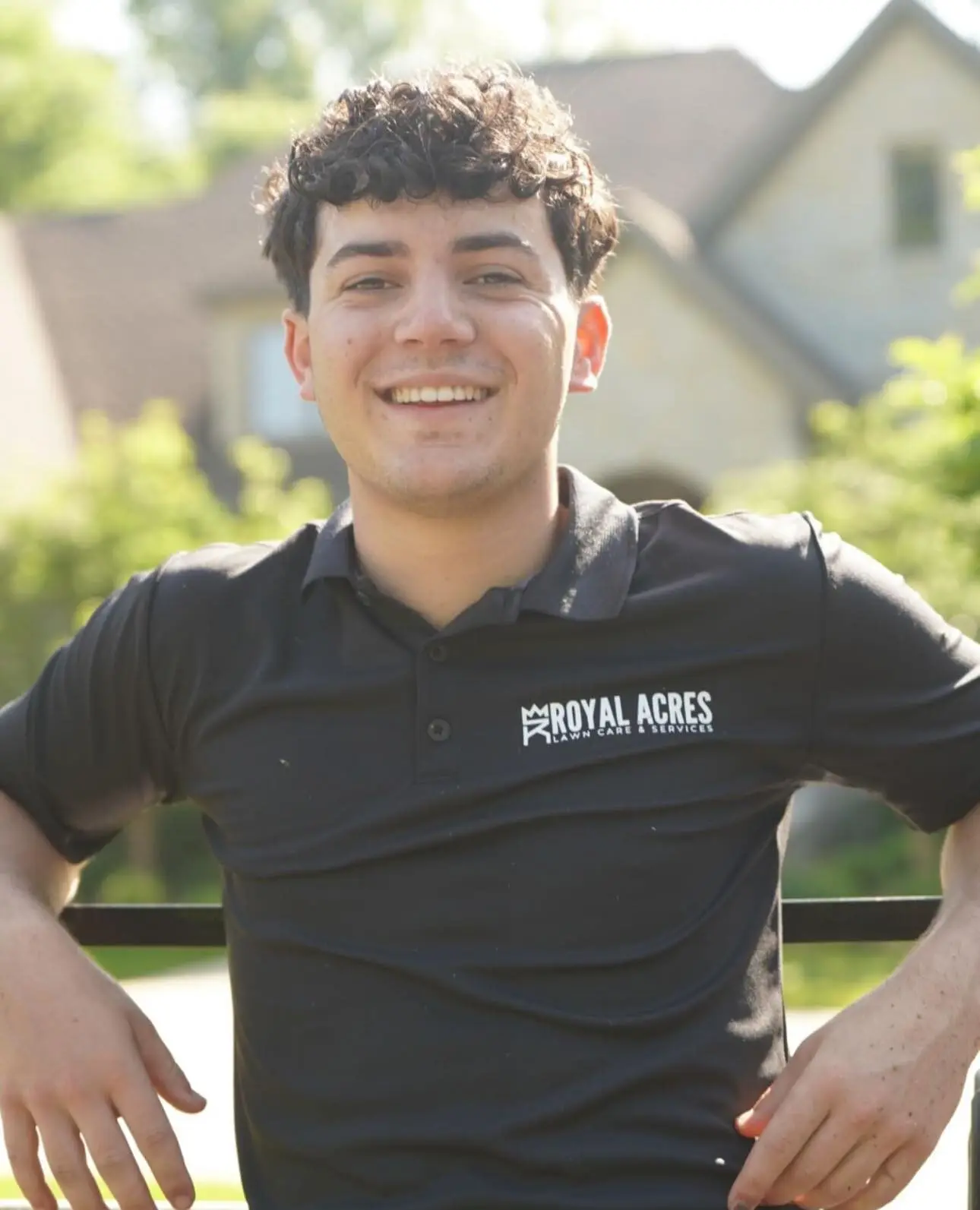 A smiling crew member in a company polo